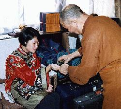 Buddhist Wedding Ceremony: Monk pouring rosewater